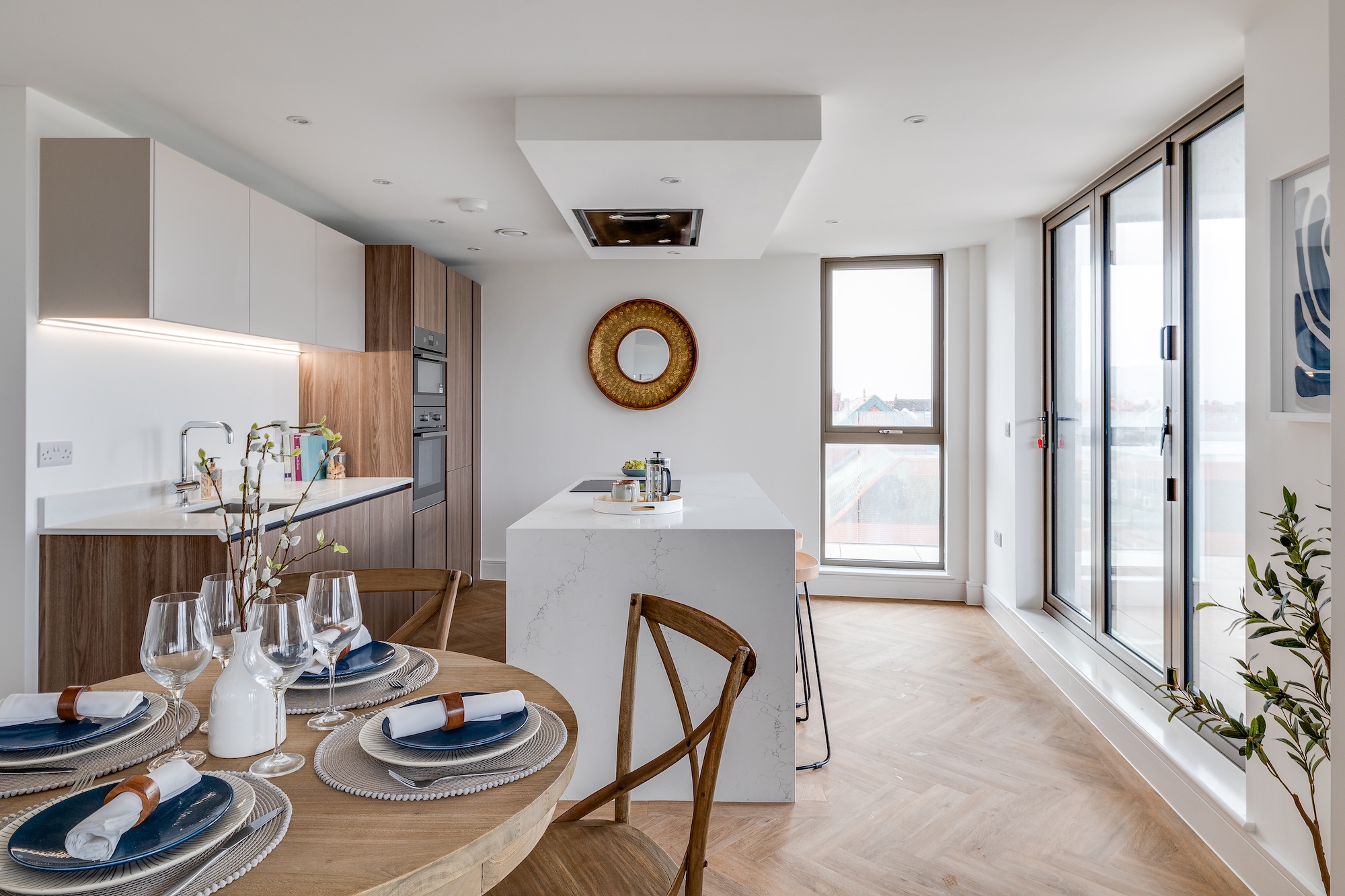 The light, modern kitchen area in one of the newly developed Hilbre Sands luxury two bedroom apartments located in West Kirby overlooking Hilbre Sands and the Dee Estuary - photograph taken by Currans Unique a specialist estate agent with offices in Chester, Heswall and North Wales.
